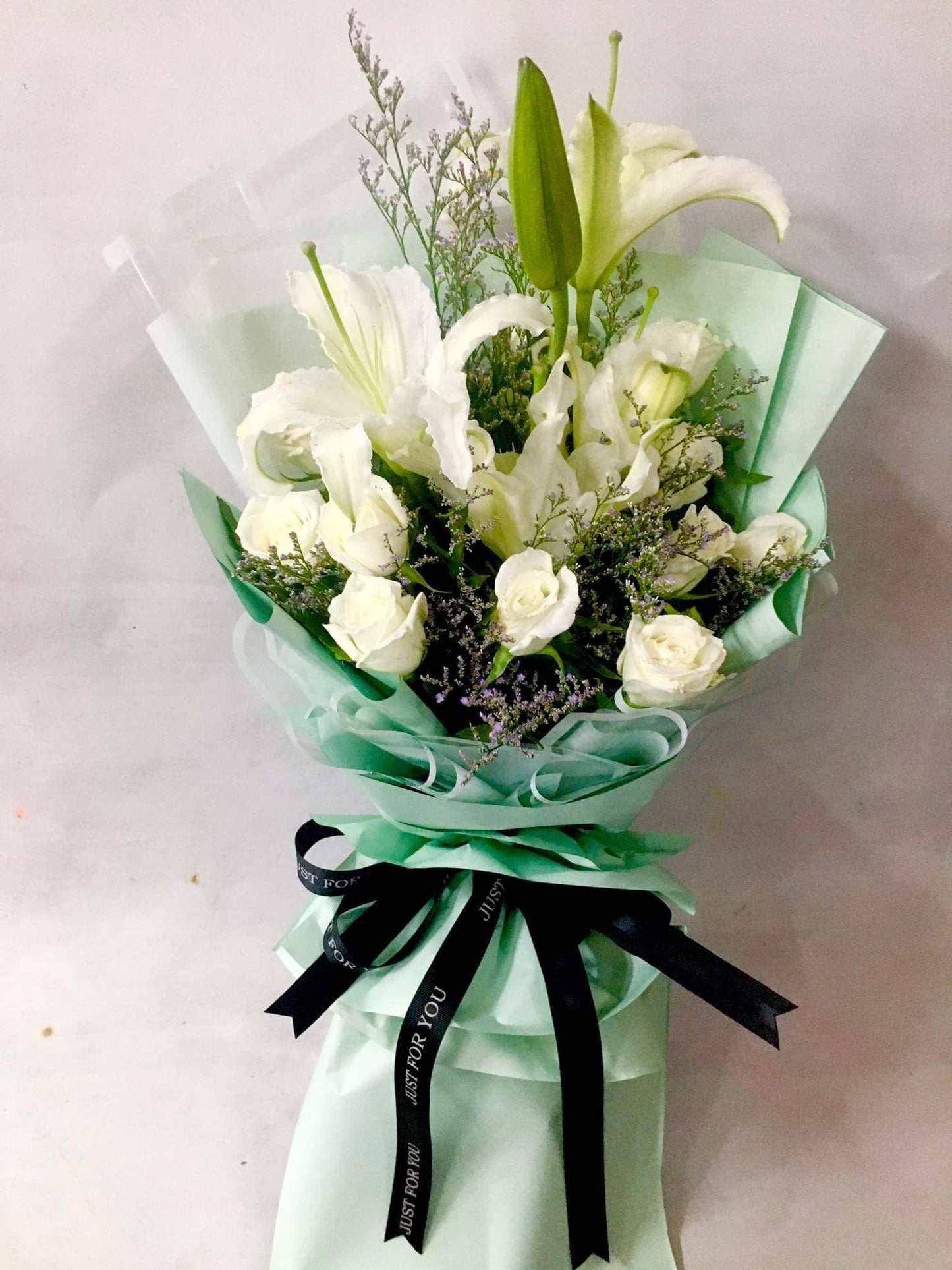 white roses and white lily bouquet